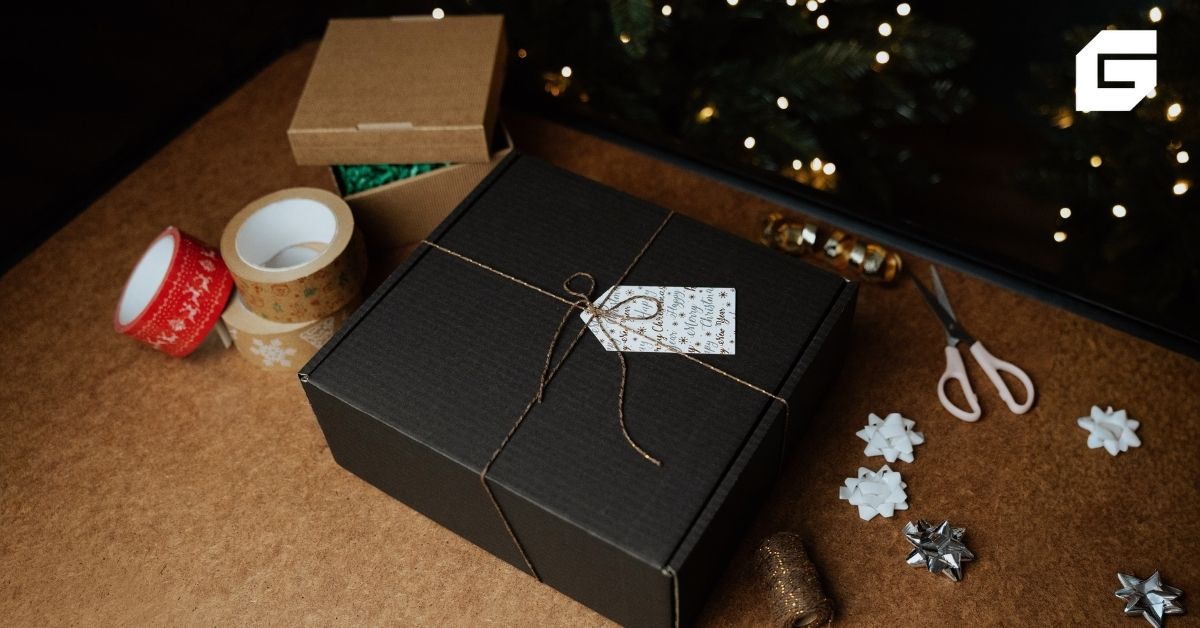 Pakowanie prezentu na Święta w czarny ozdobny karton